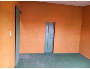 Departamento de un ambiente con un baño y una cocina pequeña